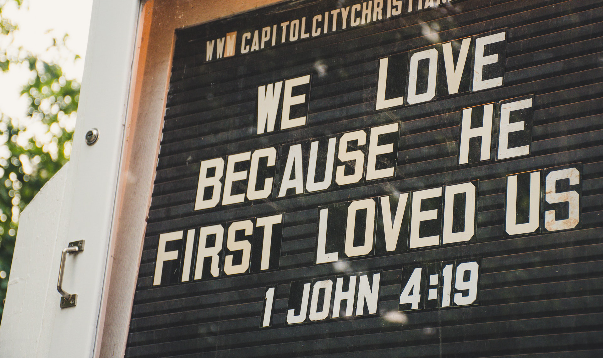 church sign with 1 John 4:19